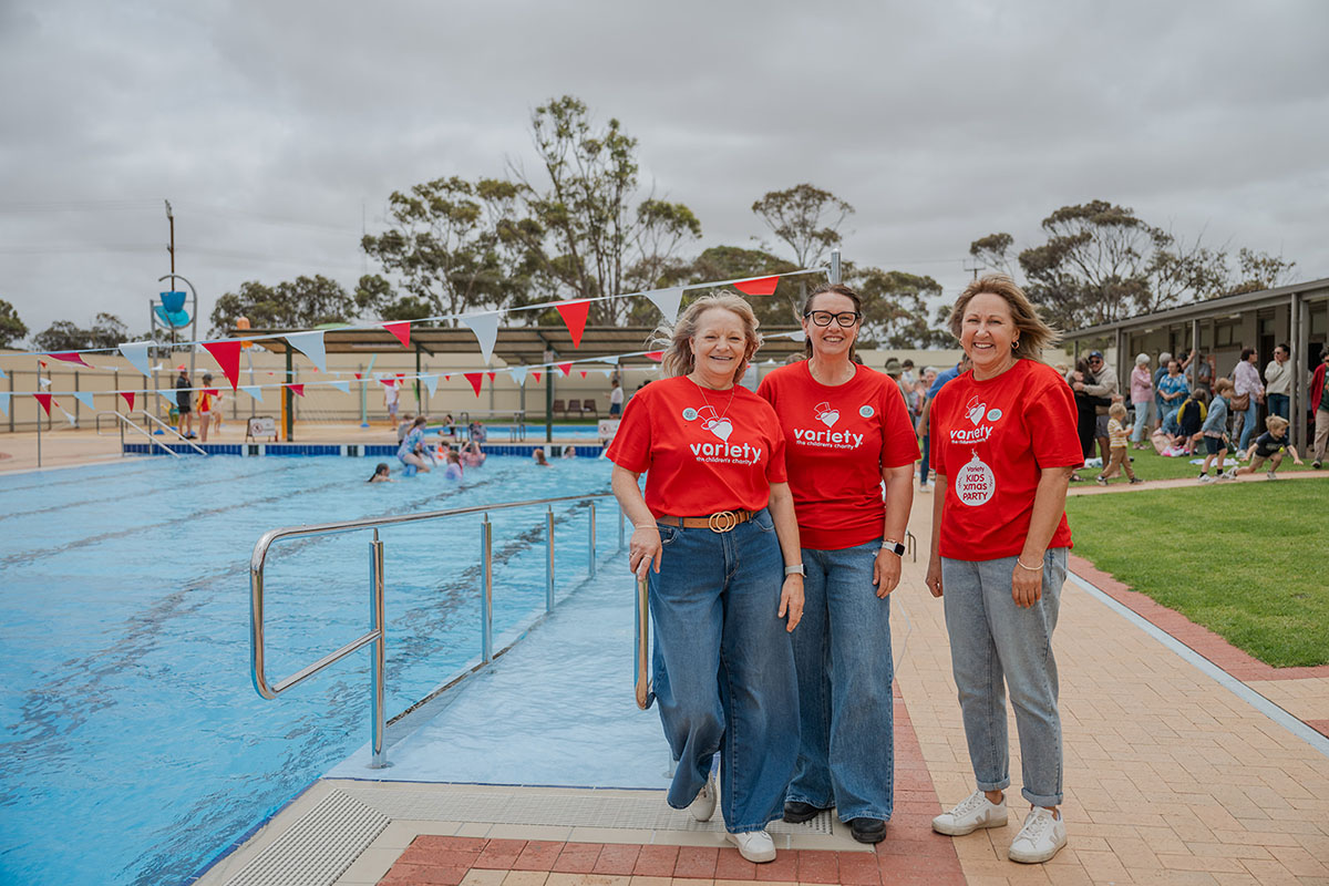 Variety team members presenting new accessible pool ramp in regional swim centre.